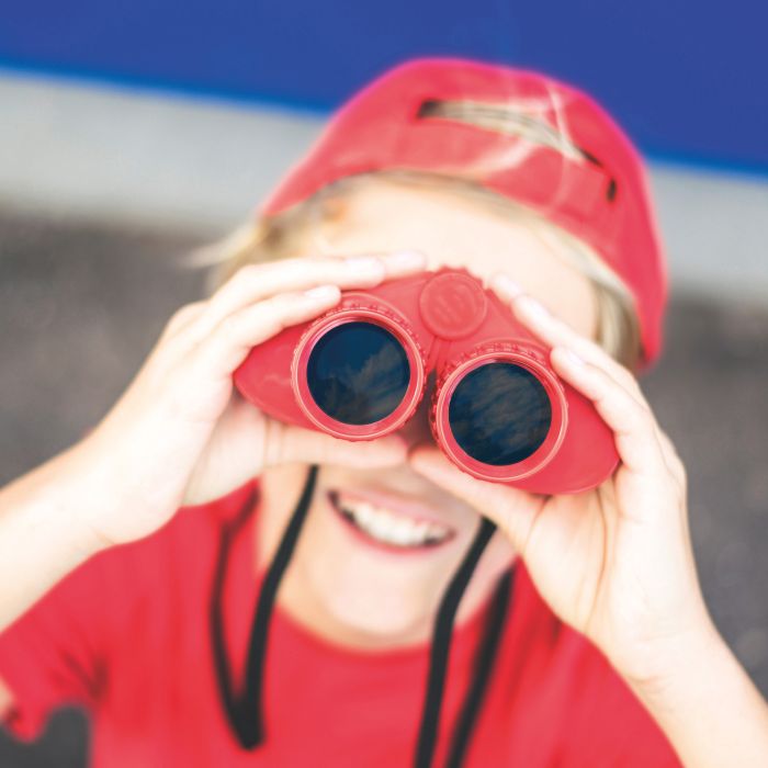 Beautiful,Boy,Looking,Away,With,A,Red,Binoculars,Isolated,On